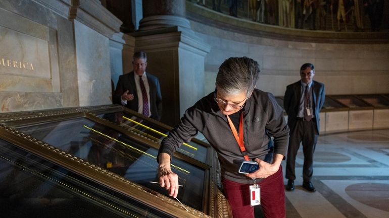 Amy Lubick, a supervisory conservator at the National Archives, runs...