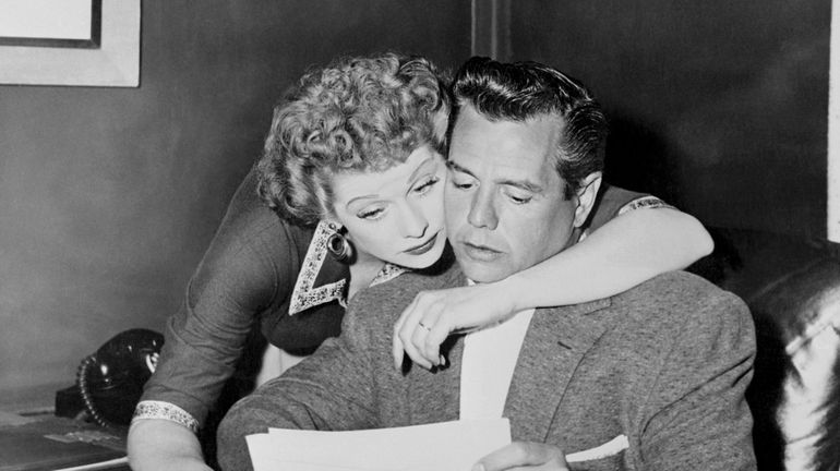  Lucille Ball and Desi Arnaz going over business matters in...