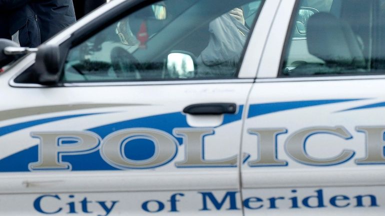 A city of Meriden, Conn., police vehicle is seen outside...