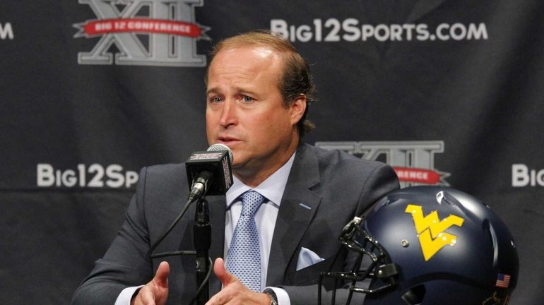 West Virginia coach Dana Holgorsen addresses the media during the...