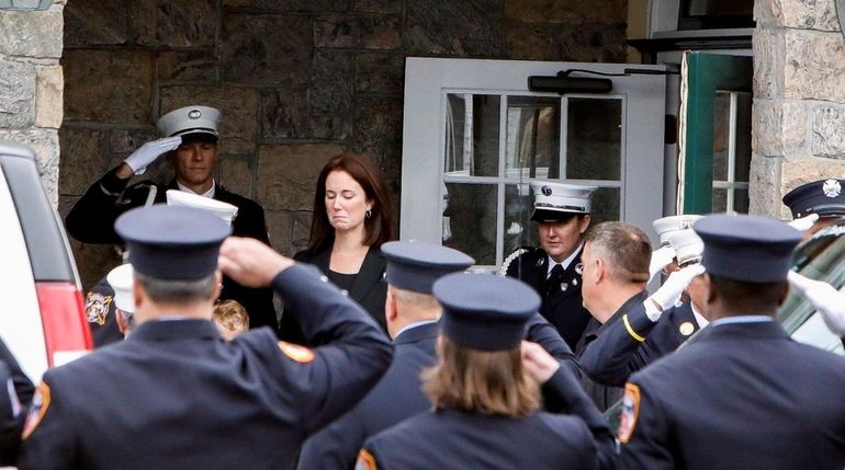 Firefighters and relatives of FDNY Battalion Chief Michael J. Fahy,...