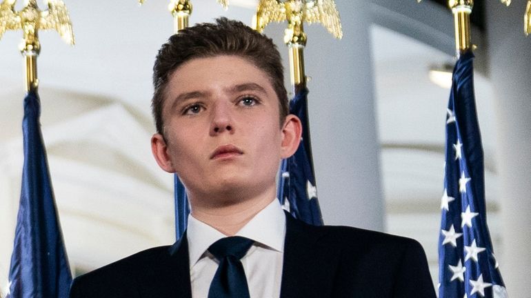 Barron Trump stands on the South Lawn of the White...