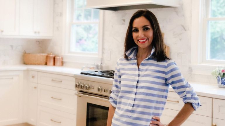 Marcella Bosch stands in the kitchen of the Huntington Village...