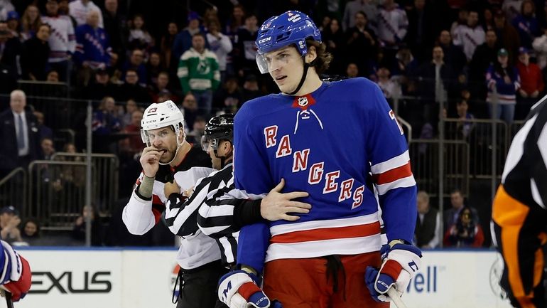 Matt Rempe #73 of the Rangers and Kurtis MacDermid #23...