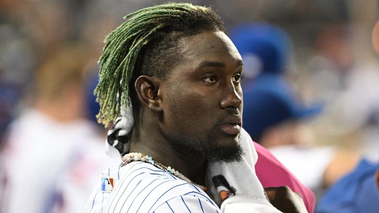 Mets second baseman Ronny Mauricio looks on from the dugout...