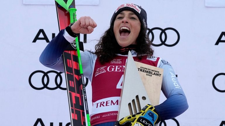 Federica Brignone of Italy celebrates her win on the podium...