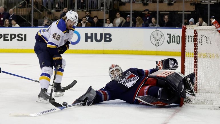 Igor Shesterkin of the New York Rangers makes a save...