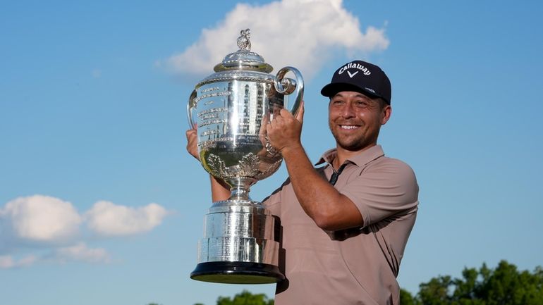 Xander Schauffele holds the Wanamaker trophy after winning the PGA...