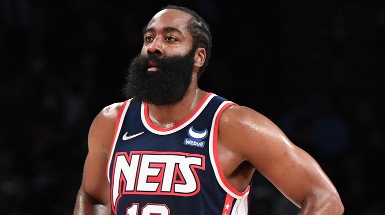 Nets guard James Harden looks on against the Phoenix Suns...