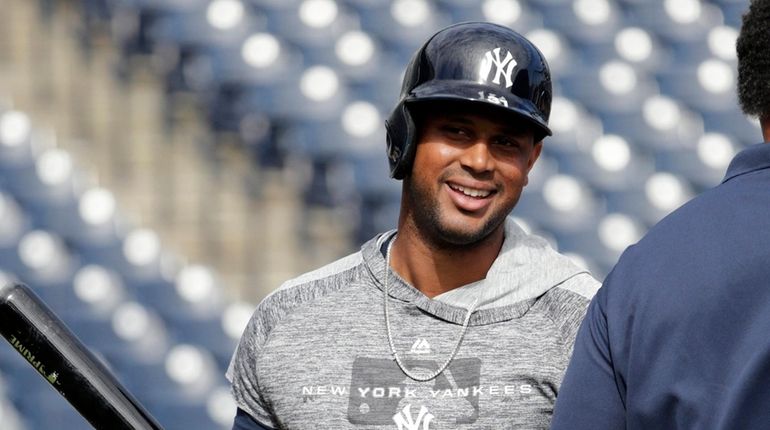 Yankees' Aaron Hicks smiles as he takes batting practice before...