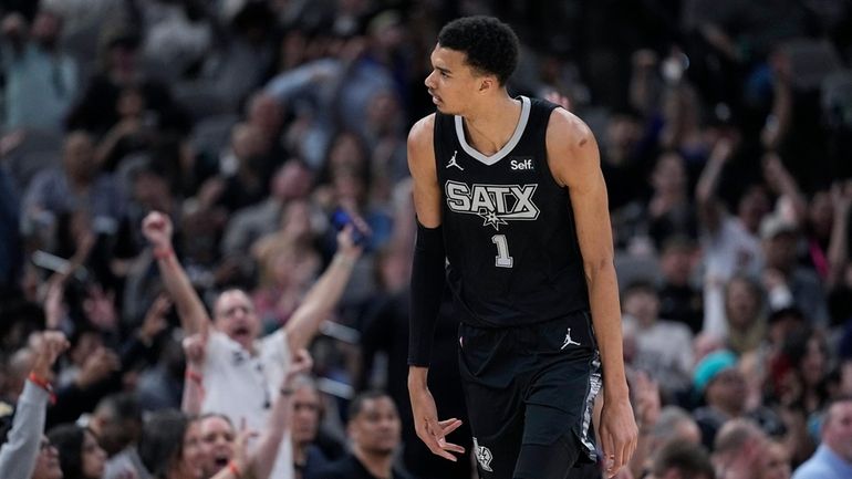 San Antonio Spurs center Victor Wembanyama (1) reacts after scoring...