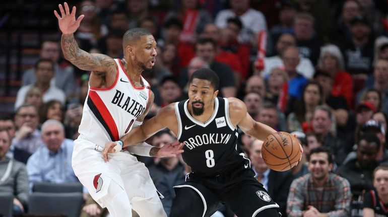 Portland Trail Blazers guard Damian Lillard, left, defends against Brooklyn...