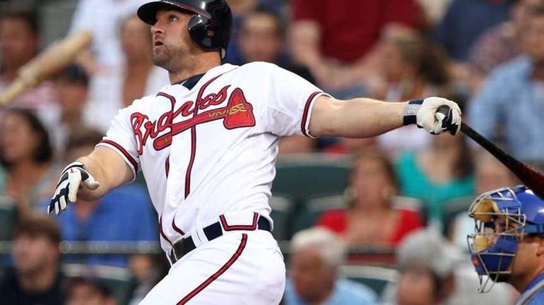 Second baseman Dan Uggla #26 of the Atlanta Braves connects...