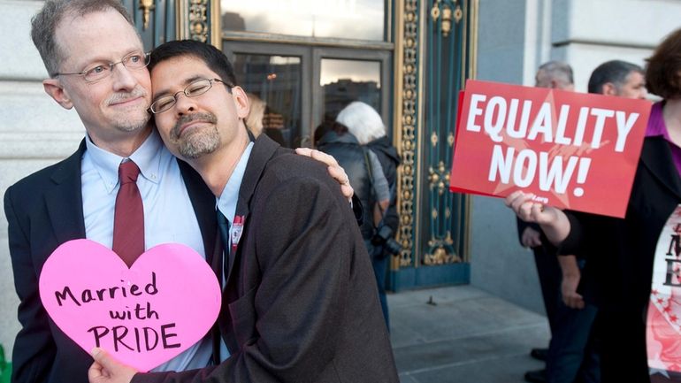 John Lewis, left, and Stuart Gaffney embrace outside San Francisco's...