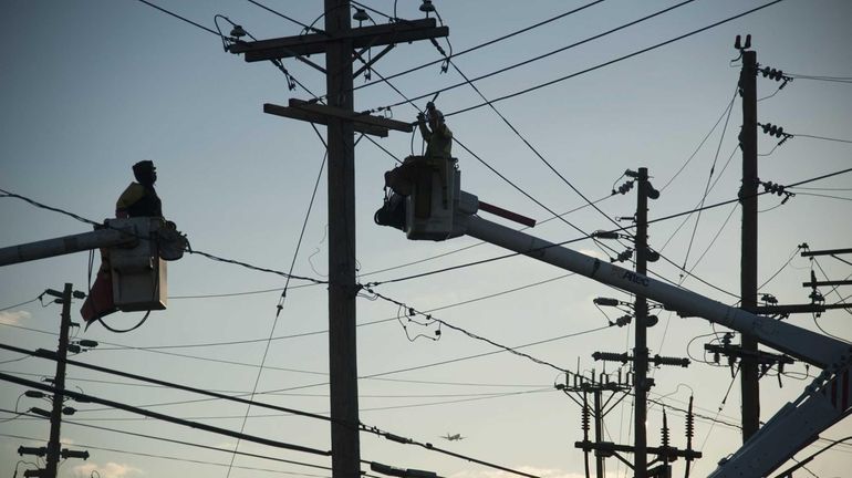 LIPA workers set up a temporary transformer station after superstorm...