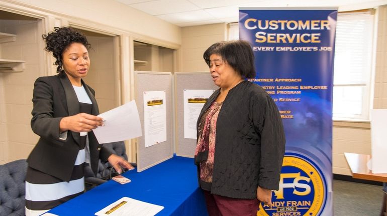 Kimberly Jerideau of the Suffolk Department of Labor, left, speaks with Patrice Broderick...