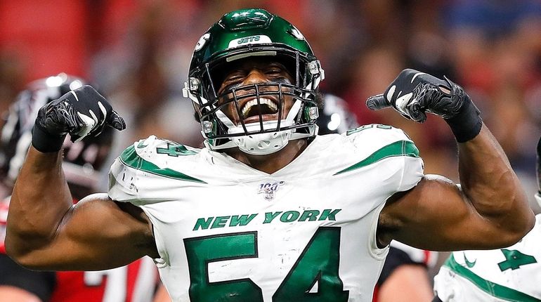 Avery Williamson of the Jets reacts after sacking Matt Ryan of the...