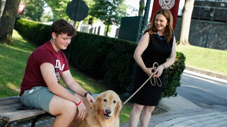 Tania Tetlow president of Fordham University holds her dog Archie...