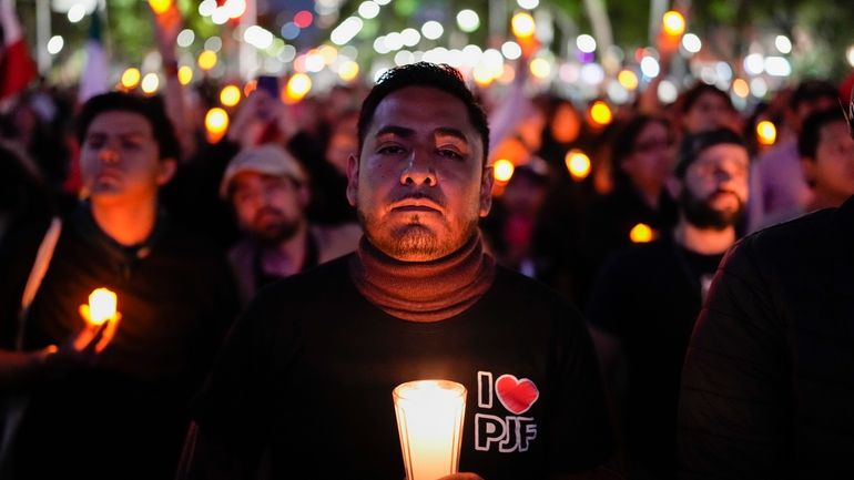 A unionized federal court worker protests against over reforms that...