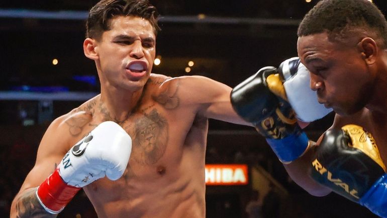 Ryan Garcia, left, hits Javier Fortuna, right, during a lightweight...