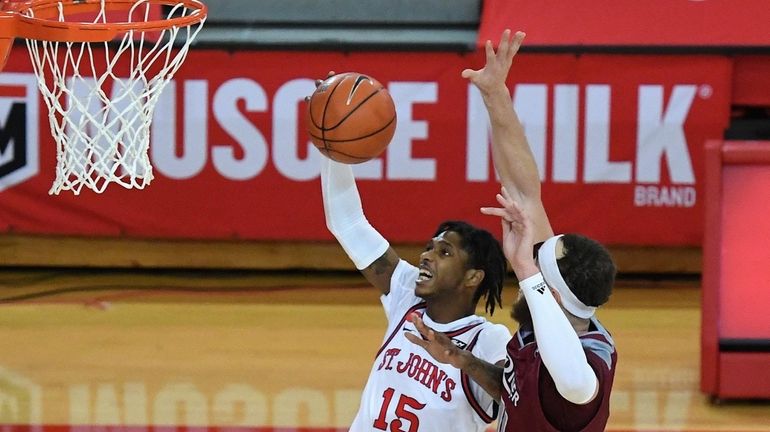 St. John's Red Storm guard Vince Cole puts up a...