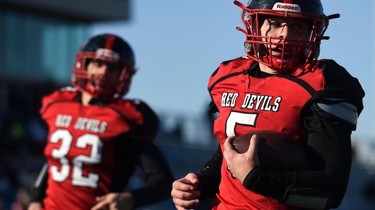 Joe Cassese #5 of Plainedge, right, rushes for a touchdown...