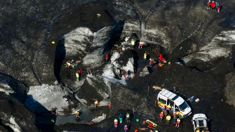 Rescue teams at the scene after an ice cave partially...