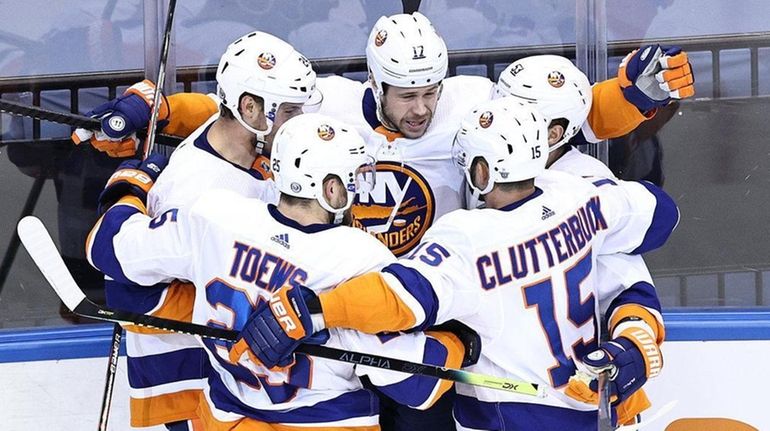 Matt Martin of the Islanders is congratulated by his teammates...