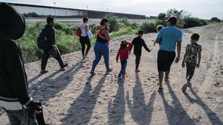 Venezuelan migrants look for a path to cross the Rio...