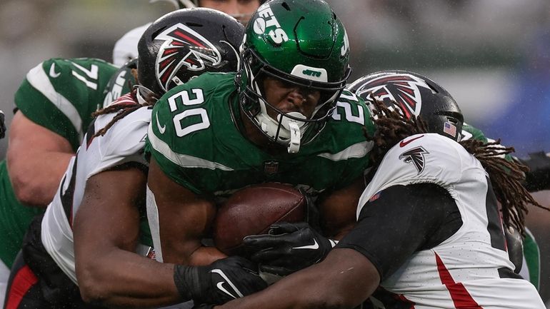 New York Jets running back Breece Hall (20) is tackled...