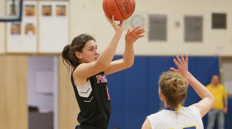 Pierson's Katie Kneeland puts one up over Mattituck's Rachel Janis in...