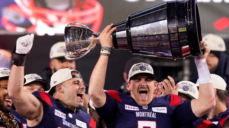 Montreal Alouettes quarterback Cody Fajardo (7) hoists the Grey Cup...