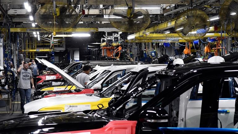 Workers assemble Ford trucks at the Ford Kentucky Truck Plant,...