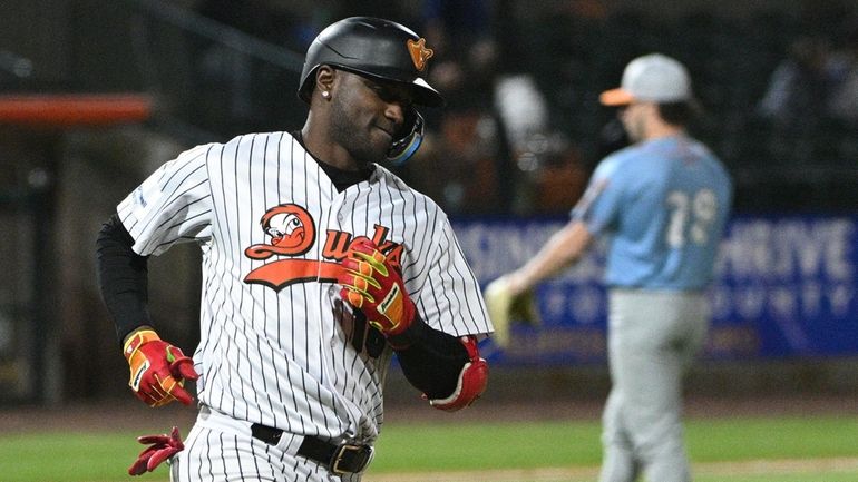 Long Island Ducks shortstop Adeiny Hechavarria rounds the bases on...