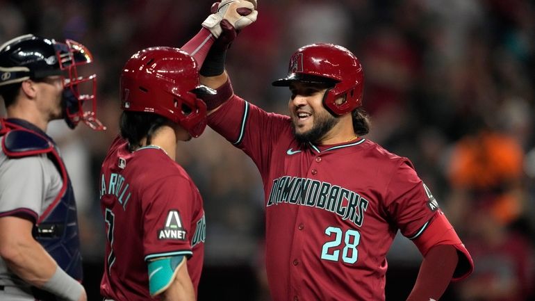 Arizona Diamondbacks' Eugenio Suárez celebrates his solo home run during...