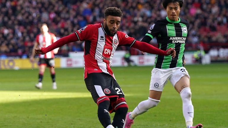 Sheffield's Jayden Bogle, left, and Brighton's Kaoru Mitoma challenge for...