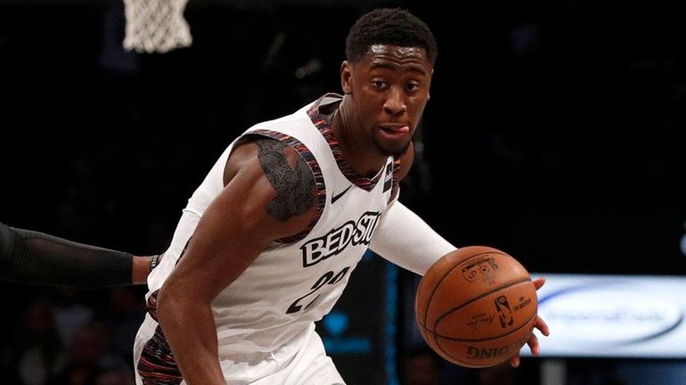 Caris LeVert of the Nets controls the ball in the...