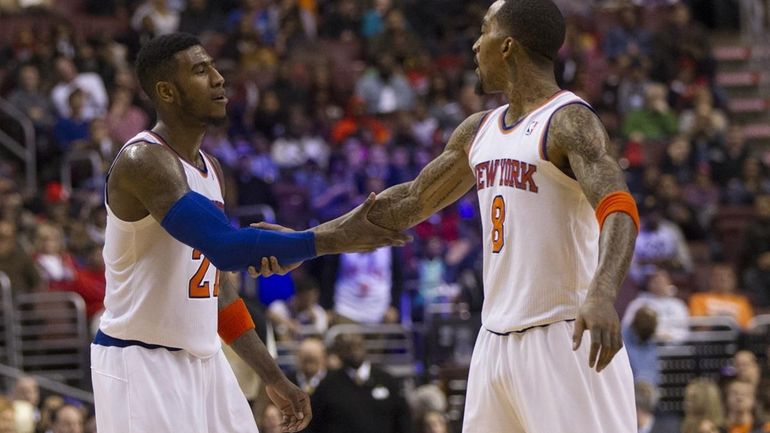The New York Knicks' Iman Shumpert, left, reacts with J.R....