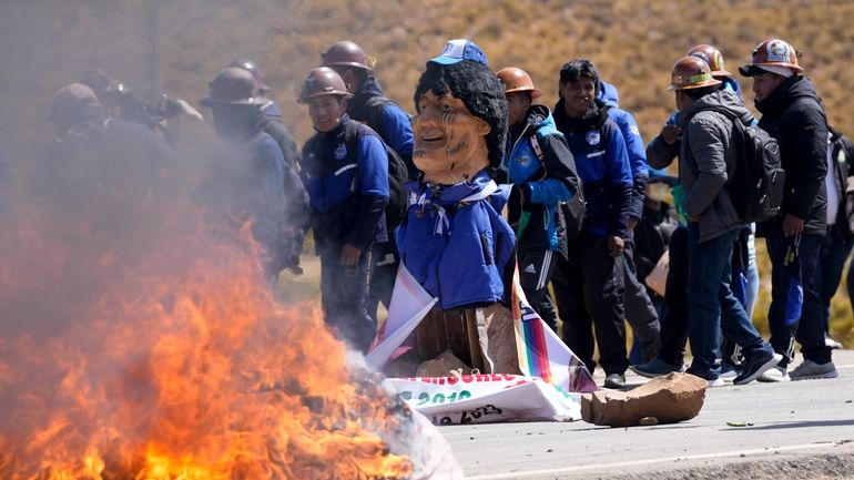 An effigy of former President Evo Morales burns on a...