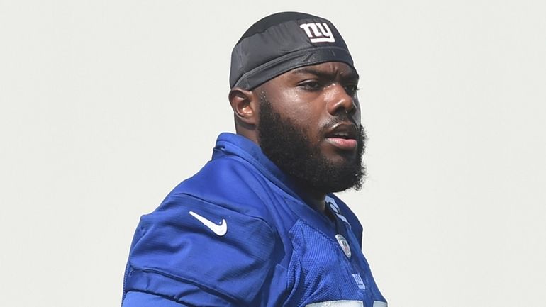 Giants tackle Andrew Thomas looks on during the first day of training...