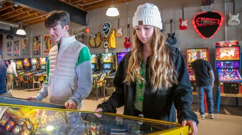 Brandon Baker, left, and Samantha Dillon, both from Medford, test their gaming...