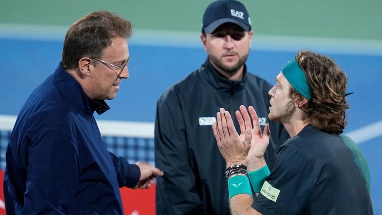 ATP Supervisor Roland Herfel, left, disqualifies Andrey Rublev during his...