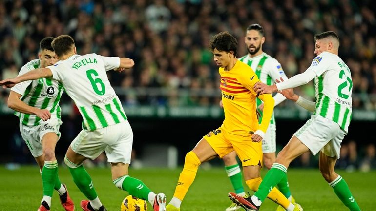 Barcelona's Joao Felix, centre right, scores his side's third goal...