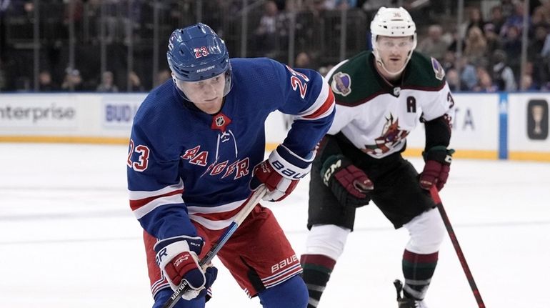 Adam Fox of the Rangers skates with the puck during the...