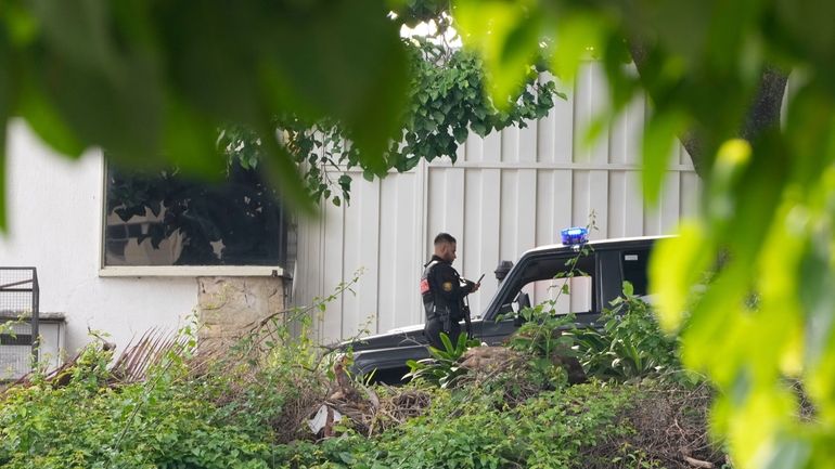 Police guard Argentina's embassy in Caracas, Venezuela, Saturday, Sept. 7,...