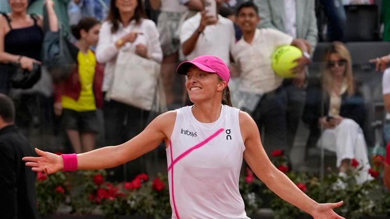 Iga Swiatek, of Poland, celebrates after defeating Aryna Sabalenka, of...