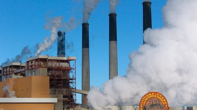 FILE- Steam rises from the huge boiler units at the...