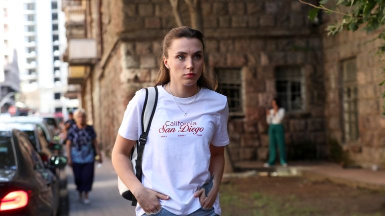 Dziana Maiseyenka, 28, walks in a street in Yerevan, Armenia,...