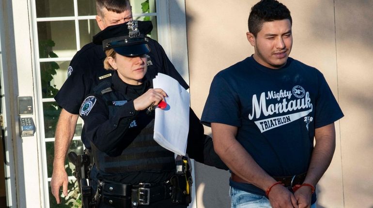 Jose Galvez-Garcia is led from his arraignment at East Hampton Town Justice...