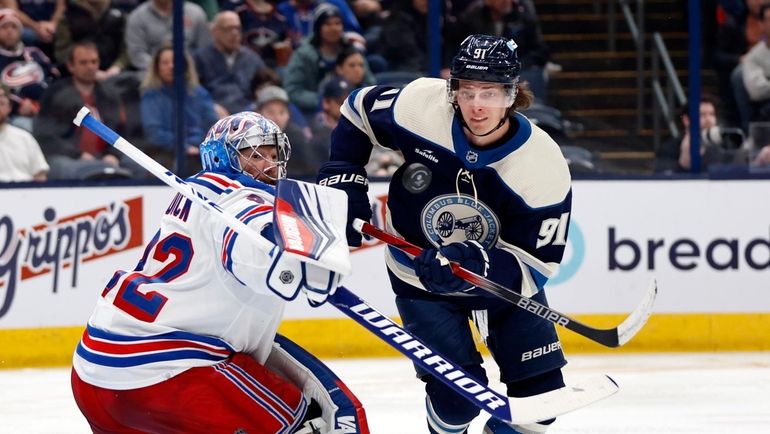 Rangers goalie Jonathan Quick, left, makes a stop in front...